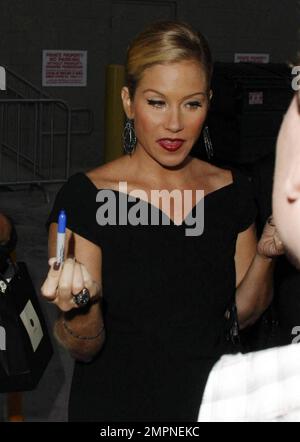 Wearing a simple black dress and sporting a short ponytail, Christina Applegate signs autographs for fans outside the 'Jimmy Kimmel Live!' studios where she made an appearance to promote her new film 'Cats and Dogs: Revenge of Kitty Galore.' Los Angeles, CA. 7/27/10. Stock Photo