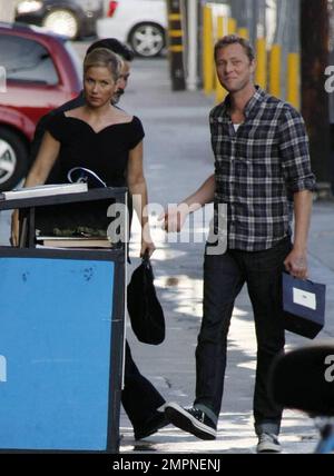 Wearing a simple black dress and sporting a short ponytail, Christina Applegate signs autographs for fans outside the 'Jimmy Kimmel Live!' studios where she made an appearance to promote her new film 'Cats and Dogs: Revenge of Kitty Galore.' Los Angeles, CA. 7/27/10. Stock Photo