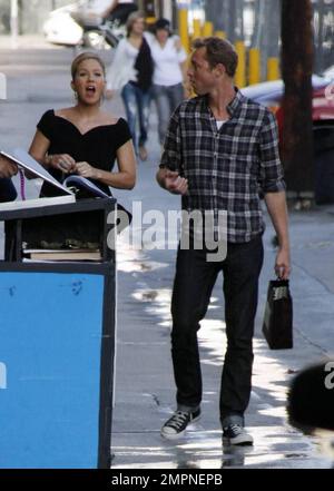 Wearing a simple black dress and sporting a short ponytail, Christina Applegate signs autographs for fans outside the 'Jimmy Kimmel Live!' studios where she made an appearance to promote her new film 'Cats and Dogs: Revenge of Kitty Galore.' Los Angeles, CA. 7/27/10. Stock Photo