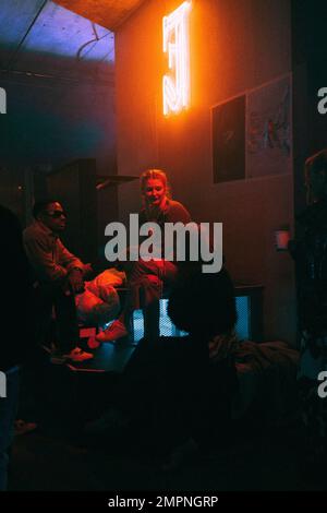 Young multiracial friends talking while enjoying at nightclub Stock Photo