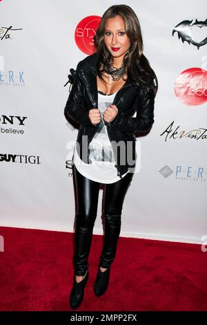 Adrienne Bailon goes for a rocker-chic look with her PVC leggings and  leather jacket at the Clandestine Industries after party during  Mercedes-Benz Fashion Week in New York, NY. 2/16/10 Stock Photo - Alamy