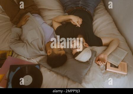 Gay couple sleeping with each other on bed at home Stock Photo