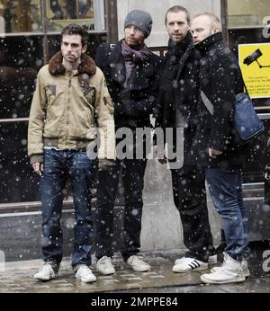 UK band Coldplay look in lively spirits as they stand outside BBC