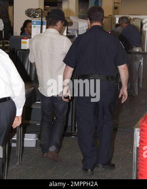 Exclusive!! Colin Farrell passed through security at Miami airport with girlfriend Polish actress Alicia Bachleda Curus. The actor had to remove his trademark boots and was wearing a pair of brown socks. Miami, FL 04/27/09     . Stock Photo