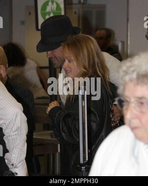 Exclusive!! Colin Farrell passed through security at Miami airport with girlfriend Polish actress Alicia Bachleda Curus. The actor had to remove his trademark boots and was wearing a pair of brown socks. Miami, FL 04/27/09 Stock Photo