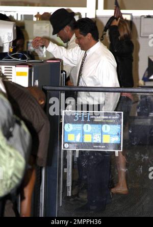 Exclusive!! Colin Farrell passed through security at Miami airport with girlfriend Polish actress Alicia Bachleda Curus. The actor had to remove his trademark boots and was wearing a pair of brown socks. Miami, FL 04/27/09     . Stock Photo