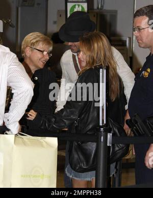 Exclusive!! Colin Farrell passed through security at Miami airport with girlfriend Polish actress Alicia Bachleda Curus. The actor had to remove his trademark boots and was wearing a pair of brown socks. Miami, FL 04/27/09 Stock Photo