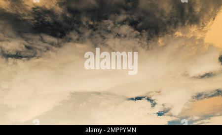 Abstract photo of blue clouds on a bright orange dark sky from the sun Stock Photo