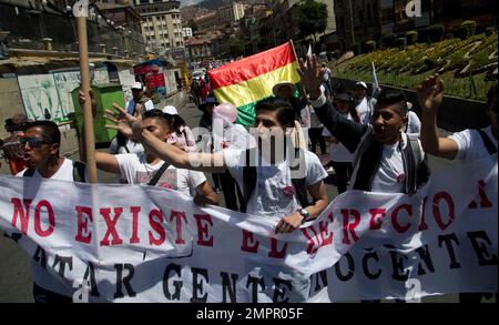 People march holding a banner with a message that reads in Spanish 'The right to kill innocent people does not exist' during an anti-abortion protest, in La Paz, Bolivia, Saturday, Nov. 25, 2017. The evangelical church in Bolivia called for a protest march to reject a bill that expands the grounds for the decriminalization of abortion. (AP Photo/Juan Karita)