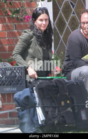 Courteney Cox looks to be wearing no makeup as she works on her script notes on the set of her feature directorial debut for Lifetime, 'Tall Hot Blonde.' Los Angeles, CA. 28th March 2012. Stock Photo