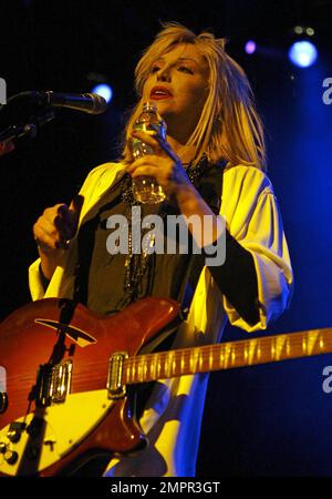 Courtney Love smokes a cigarette on stage as she performs live in ...
