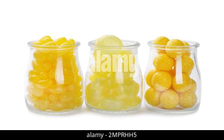 Different tasty lemon drops in jars isolated on white Stock Photo