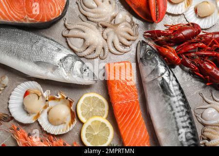 Fresh fish and seafood on marble table, flat lay Stock Photo