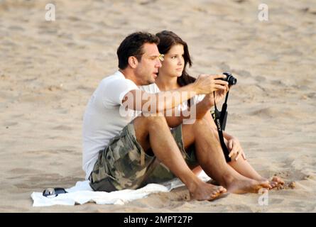 'Hawaii Five-0' star and American comedian Dane Cook spends a romantic evening on the beach at sunset with his reported girlfriend, a beautiful brunette. The two set up a blanket and cuddled by the surf. They also snapped photos of each other, even setting up a table and setting the timer on the camera to take some shots together. Honolulu, HI. 2nd September 2011. Stock Photo