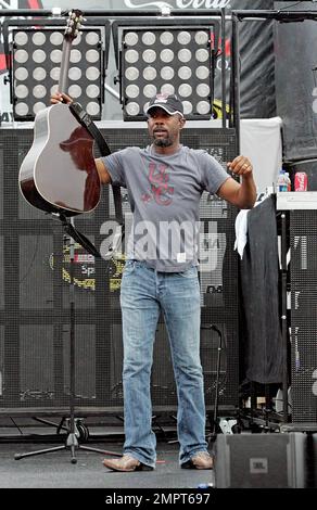 Lead singer of Hootie & the Blowfish and CMA New Artist of the Year winner, Darius Rucker performs live in the rain prior to the NASCAR Coke Zero 400 at Daytona International Speedway.  Despite the drizzle the rock-turned-country singer seemed happy as he moved around the stage singing and playing his guitar. Daytona Beach, FL. 07/03/10.   . Stock Photo