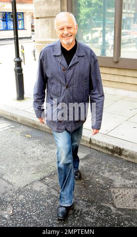 '70s and '80s hearthrob singer and actor David Essex waves and smiles for the cameras as he leaves the BBC. London, UK. 7/31/10.     . Stock Photo