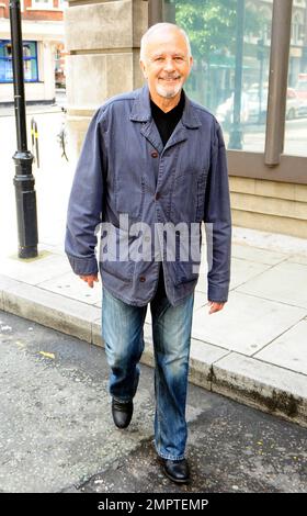 '70s and '80s hearthrob singer and actor David Essex waves and smiles for the cameras as he leaves the BBC. London, UK. 7/31/10.   . Stock Photo