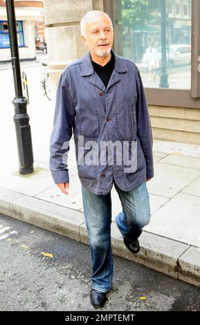 '70s and '80s hearthrob singer and actor David Essex waves and smiles for the cameras as he leaves the BBC. London, UK. 7/31/10.     . Stock Photo