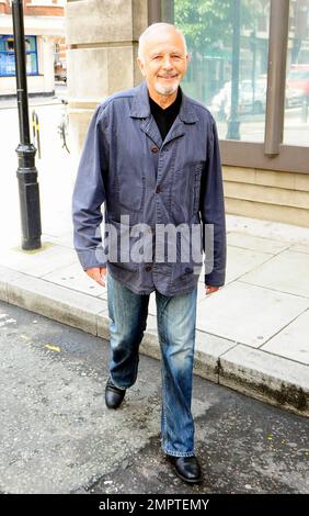 '70s and '80s hearthrob singer and actor David Essex waves and smiles for the cameras as he leaves the BBC. London, UK. 7/31/10.     . Stock Photo