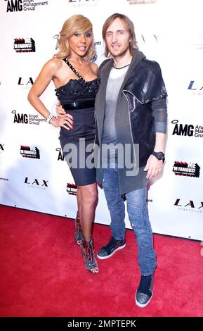 Grammy Award winning French house music producer and DJ David Guetta and wife Cathy Guetta pose for photographers at LAX Nightclub inside the Luxor Hotel during the launch party for 'F*** Me I'm Famous!', a series of compilation electronic dance music albums. Las Vegas, NV. 03/26/11. Stock Photo