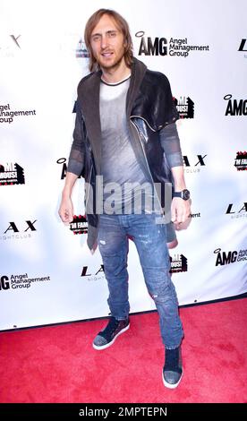 Grammy Award winning French house music producer and DJ David Guetta and wife Cathy Guetta pose for photographers at LAX Nightclub inside the Luxor Hotel during the launch party for 'F*** Me I'm Famous!', a series of compilation electronic dance music albums. Las Vegas, NV. 03/26/11. Stock Photo