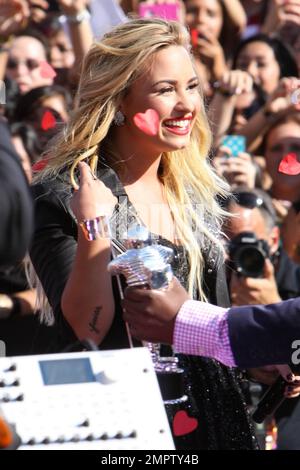 Wearing a black sequenced mini dress with a leather jacket and black ankle boots, singer Demi Lovato performs live the 2012 MTV Video Music Awards held at the Staples Center in Los Angeles, CA. 6th September 2012. Stock Photo