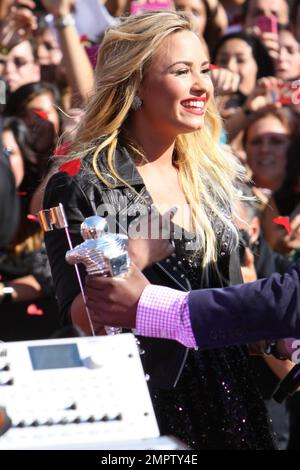 Wearing a black sequenced mini dress with a leather jacket and black ankle boots, singer Demi Lovato performs live the 2012 MTV Video Music Awards held at the Staples Center in Los Angeles, CA. 6th September 2012. Stock Photo