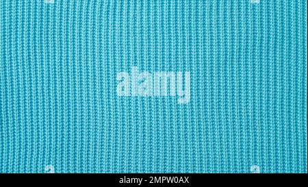 The texture of a knitted woolen fabric blue. Background. Close up. Warm Textile Material as a backdrop Stock Photo
