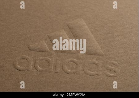 New york, USA - January 5, 2022: Pressed on paper Adidas brand logo on brown recycled eco paper Stock Photo