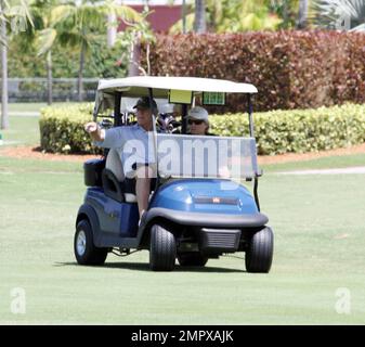 EXCLUSIVE!! Michael Douglas plays a round of golf with Pat Riley and a pal on a sunny day in Miami Beach. Douglas, who is recovering from Cancer appeared to be  huffing and puffing during the 18 hole game. Miami Beach, FL. 4th April 2012. Stock Photo