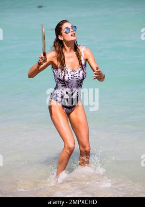 Doutzen Kroes is spotted playing paddle ball seaside with husband Sunnery James. They were joined by a friend and director Michael Bay. The 30 year old model looked amazing in a tiger print one piece swimsuit. Miami Beach, FL. March 30, 2015. Stock Photo