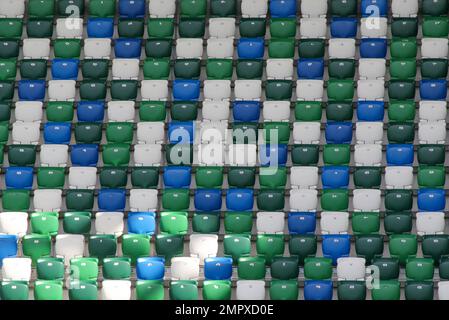 Green blue white coloured seats in stadium. Rows of modern football stadium tip-up seats Windsor Park, Belfast. Stock Photo