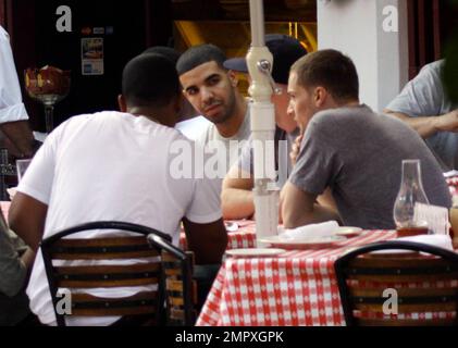 EXCLUSIVE!! Canadian actor and Grammy-nominated recording artist Drake (aka Aubrey Drake Graham) enjoys a meal with friends on Miami Beach while celebrating his 24th birthday during a trip to Miami. He was honored at a birthday bash sponsored by Grey Goose Vodka over the weekend, where he was named a Grey Goose Rising Icon. Drake's first studio album, 'Thank Me Later,' was released on June 15 and debuted at number one on the Billboard 200 chart. Miami Beach, FL. 10/25/10. Stock Photo