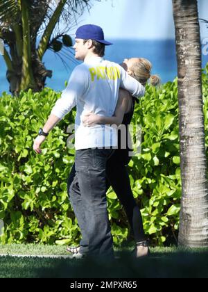 Exclusive!! Actress and Singer Hilary Duff and her hockey player boyfriend, Mike Comrie, enjoy an affectionate cuddle to keep warm during a stroll in the blustery ocean breeze . The couple jetted out of LA for a New Year vacation together at a luxury resort in the Caribbean. Duff's strappy sandals revealed a 'Let It Be' tattoo.  Caribbean 01/22/09 Stock Photo