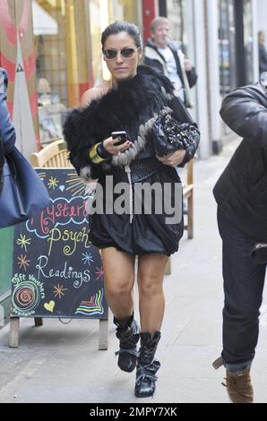 EastEnders star Jessie Wallace wearing a black bubble dress with a fur wrap, sunglasses, black laced up high heel boots, a matching black purse while carrying her iPhone in hand is seen walking through London's West End.  Wallace was recently crowned Best Actress at the 2011 Inside Soap Awards. London, UK. 20th October 2011.   . Stock Photo