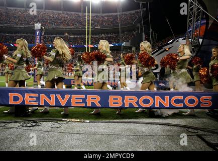 The Denver Broncos cheerleaders wear green to celebrate the NFL's Salute to  Service prior to an NFL football game against the New England Patriots,  Sunday, Nov. 12, 2017, in Denver. (AP Photo/David