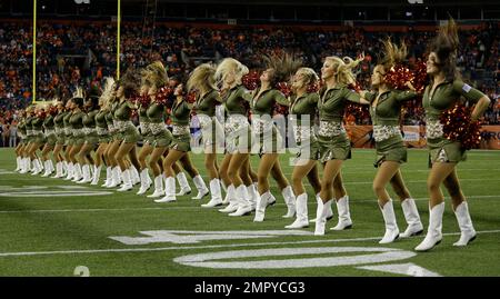 The Denver Broncos cheerleaders wear green to celebrate the NFL's Salute to  Service prior to an NFL football game against the New England Patriots,  Sunday, Nov. 12, 2017, in Denver. (AP Photo/David