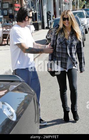 Carmen Electra and Korn guitarist Rob Patterson shoe shopping at ...