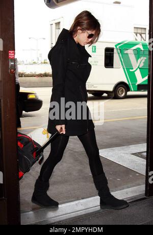 EXCLUSIVE!! After accompanying boyfriend George Clooney to the Academy Awards last night, Elisabetta Canalis is dressed down and looking a bit less glamorous as she arrives to catch a flight out of LAX. Los Angeles, CA. 3/8/10.   . Stock Photo