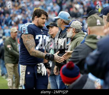 Tennessee Titans tackle Taylor Lewan (77) shakes hands with military  veterans during halftime at NFL football game between the Titans and the  Cincinnati Bengals Sunday, Nov. 12, 2017, in Nashville, Tenn. (AP