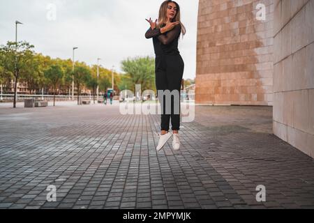 young blonde contemporary dancer dancing on the street. Stock Photo