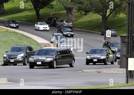 Mourners leave Forest Lawn Memorial Cemetery in limousines after funeral services were held for legendary actress Elizabeth Taylor. Taylor was buried in the cemetary next to hear parents and near friend Michael Jackson and other celebrities. The actress died yesterday of Congestive Heart Failure after being hospitalized for weeks. Los Angeles, CA. 3/24/11. Stock Photo