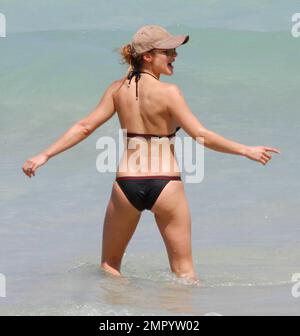 Elsa Pataky shows off her amazing figure whilst strolling along the beach in a black bikini and wearing a baseball cap.   The Spanish actress spent time in Miami this week to promote her new movie 'Fast Five.' Miami Beach, FL. 4/7/11. Stock Photo