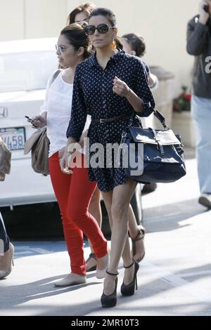 "Desperate Housewives" star Eva Longoria was spotted outside Cafe Med in West Hollywood in a dark blue, shirt style, polka-dotted dress matched with a brown Coach purse and accessorized with large sunglasses and brown high heels. It's been reported that reality star Kim Kardashian, who recently announced her split from husband Kris Humphries, has been reaching out to Eva for support through her divorce drama. In reports, an insider revealed, ÒKim has a lot of support from friends and family but Eva has been particularly helpful to her.Ó The insider continues by stating, ÒShe has been married t Stock Photo