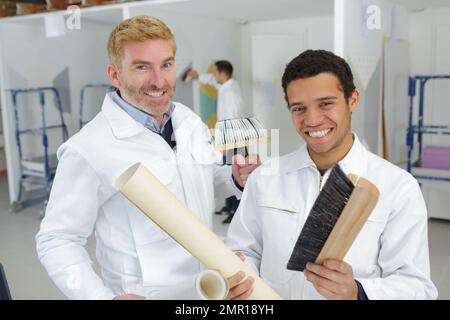 happy teacher and apprentice learning how to paint Stock Photo