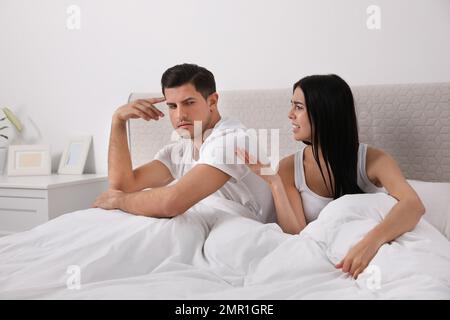 Couple with relationship problems quarreling in bedroom Stock Photo