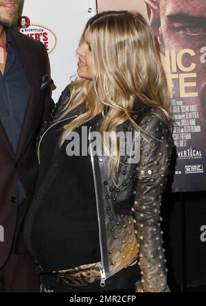 Showing off her baby bump as she awaits the arrival of her first child any day now, Fergie was spotted arriving at the premiere of her husband Josh Duhamel's latest film, 'Scenic Route' held at the Chinese 6 Theatre in Hollywood. The 38 year old 'Black Eyed Peas' singer looked amazing in a black studded leather jacket with a sheer black top and black leather pants. Fergie and Josh are reportedly awaiting the arrival of their son at any moment but that did not stop Fergie from coming out to support her hunky husband at his movie premiere. Looking all-aglow, the happy couple appeared in great sp Stock Photo