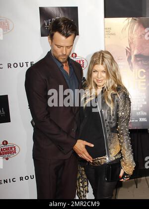 Showing off her baby bump as she awaits the arrival of her first child any day now, Fergie was spotted arriving at the premiere of her husband Josh Duhamel's latest film, 'Scenic Route' held at the Chinese 6 Theatre in Hollywood. The 38 year old 'Black Eyed Peas' singer looked amazing in a black studded leather jacket with a sheer black top and black leather pants. Fergie and Josh are reportedly awaiting the arrival of their son at any moment but that did not stop Fergie from coming out to support her hunky husband at his movie premiere. Looking all-aglow, the happy couple appeared in great sp Stock Photo