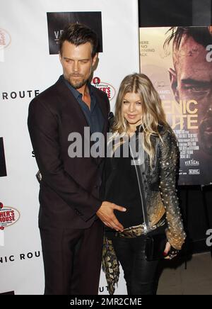 Showing off her baby bump as she awaits the arrival of her first child any day now, Fergie was spotted arriving at the premiere of her husband Josh Duhamel's latest film, 'Scenic Route' held at the Chinese 6 Theatre in Hollywood. The 38 year old 'Black Eyed Peas' singer looked amazing in a black studded leather jacket with a sheer black top and black leather pants. Fergie and Josh are reportedly awaiting the arrival of their son at any moment but that did not stop Fergie from coming out to support her hunky husband at his movie premiere. Looking all-aglow, the happy couple appeared in great sp Stock Photo