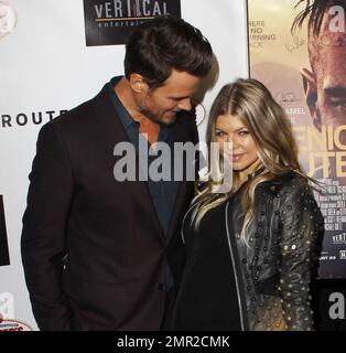 Showing off her baby bump as she awaits the arrival of her first child any day now, Fergie was spotted arriving at the premiere of her husband Josh Duhamel's latest film, 'Scenic Route' held at the Chinese 6 Theatre in Hollywood. The 38 year old 'Black Eyed Peas' singer looked amazing in a black studded leather jacket with a sheer black top and black leather pants. Fergie and Josh are reportedly awaiting the arrival of their son at any moment but that did not stop Fergie from coming out to support her hunky husband at his movie premiere. Looking all-aglow, the happy couple appeared in great sp Stock Photo